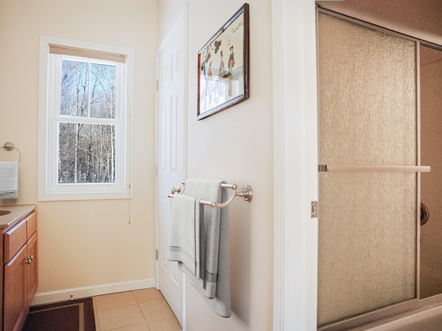 bathroom featuring vanity, baseboards, and tile patterned floors