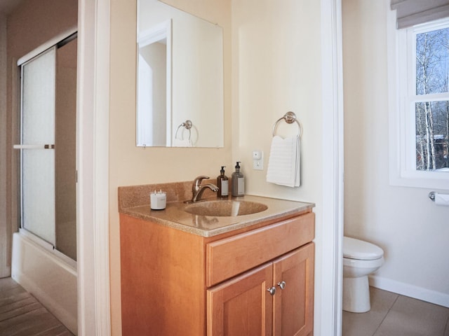 bathroom with baseboards, toilet, tile patterned flooring, an enclosed shower, and vanity