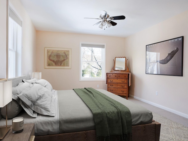 carpeted bedroom with ceiling fan and baseboards