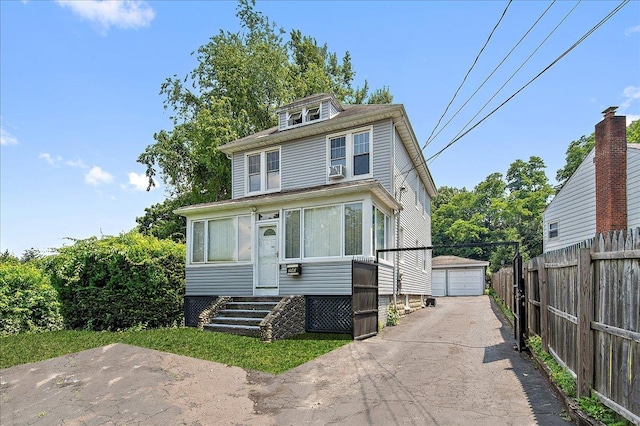 view of front of property featuring a garage and an outdoor structure