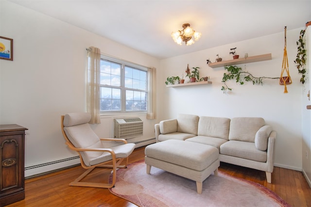 living room featuring hardwood / wood-style flooring, a baseboard radiator, and a wall unit AC