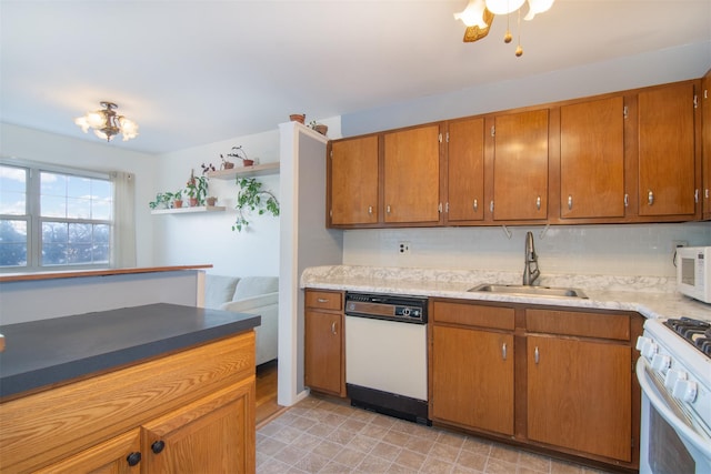 kitchen with sink, white appliances, and backsplash