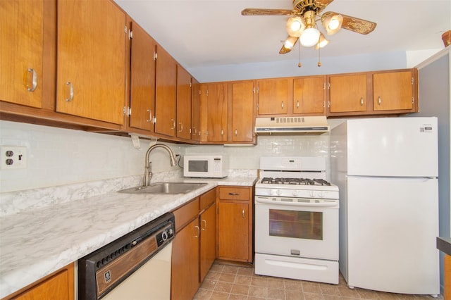 kitchen featuring ceiling fan, sink, white appliances, and decorative backsplash