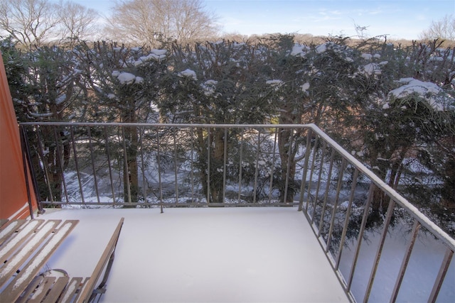 view of snow covered back of property