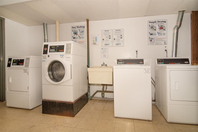 laundry room with washing machine and dryer and sink