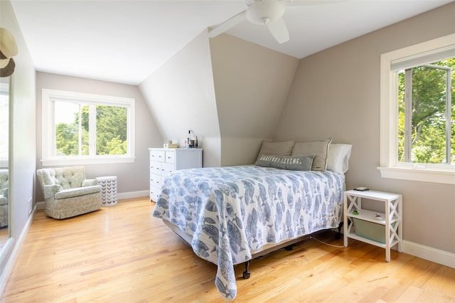 bedroom featuring ceiling fan, wood-type flooring, and lofted ceiling