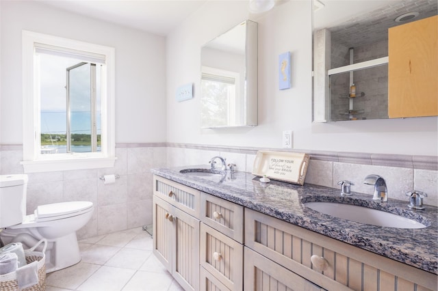 bathroom featuring an enclosed shower, vanity, tile walls, tile patterned flooring, and toilet