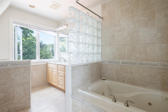 bathroom featuring vanity, tiled bath, tile patterned floors, and tile walls