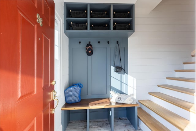 mudroom with wood walls