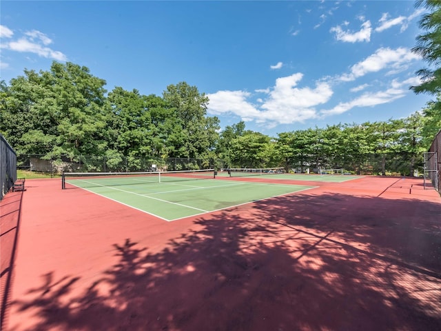 view of tennis court with basketball hoop