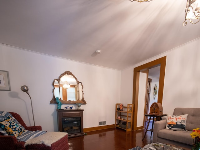 living room with dark hardwood / wood-style flooring and ornamental molding