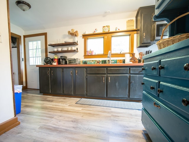 kitchen featuring light wood-type flooring and sink