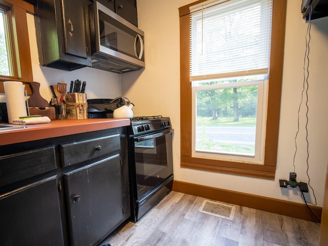 kitchen featuring light hardwood / wood-style flooring and black range oven