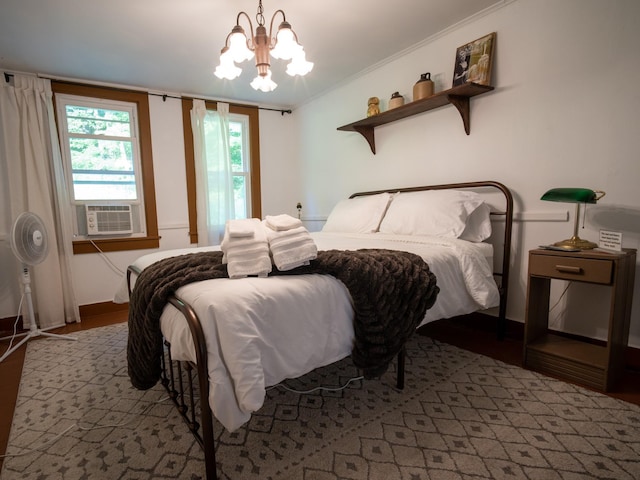 bedroom featuring a chandelier, light wood-type flooring, cooling unit, and ornamental molding