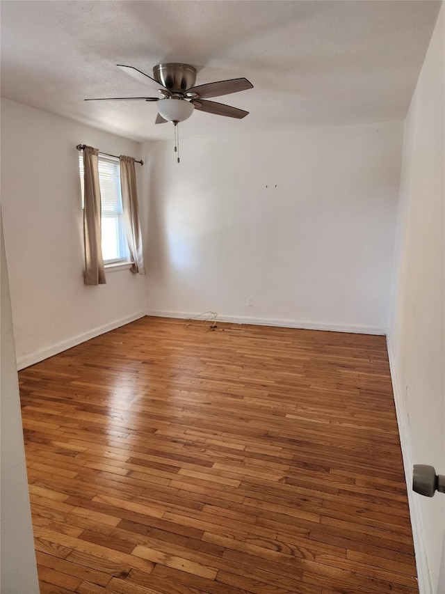 unfurnished room featuring ceiling fan and dark hardwood / wood-style flooring