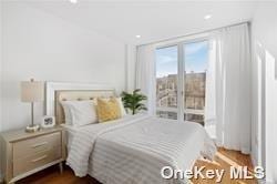 bedroom with dark hardwood / wood-style floors