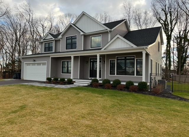 view of front of home with a front yard and a garage