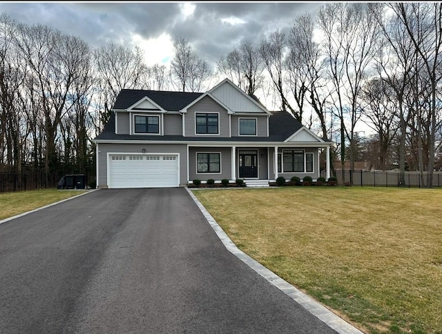 view of front facade featuring a front lawn, a porch, and a garage