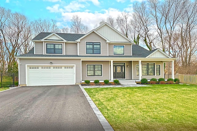 view of front of property featuring a garage, covered porch, and a front lawn