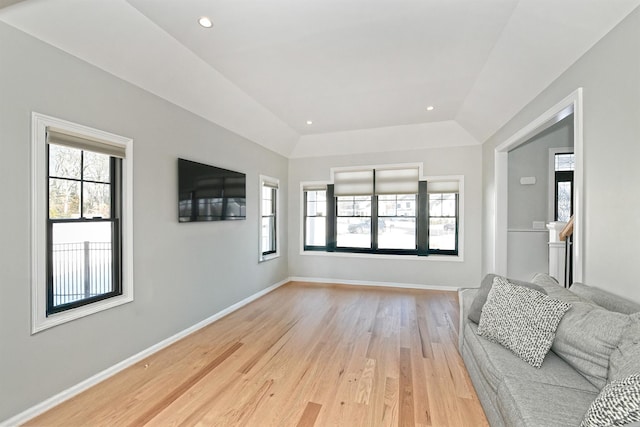 living room featuring vaulted ceiling and light wood-type flooring