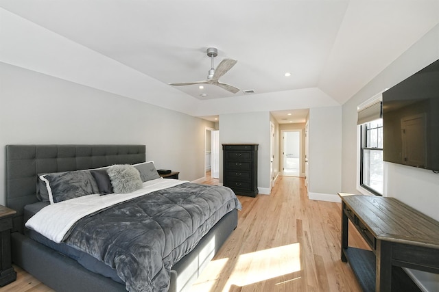 bedroom featuring light hardwood / wood-style flooring, ceiling fan, and vaulted ceiling