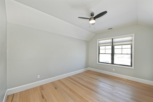 additional living space with hardwood / wood-style floors, vaulted ceiling, and ceiling fan