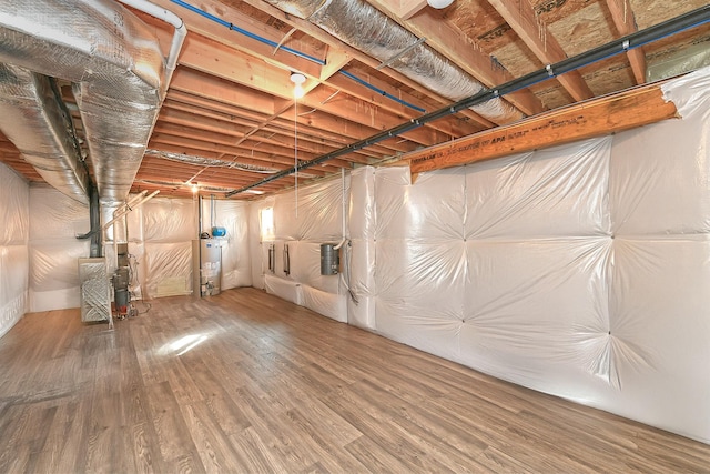 basement with gas water heater and hardwood / wood-style floors