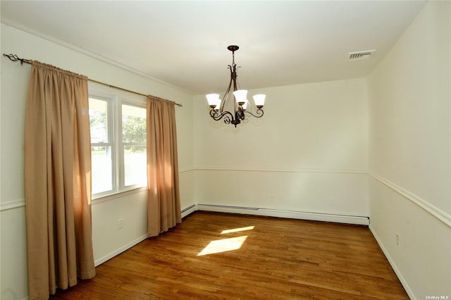 empty room with hardwood / wood-style flooring, a baseboard radiator, and a notable chandelier