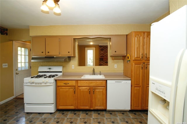 kitchen with backsplash, sink, and white appliances