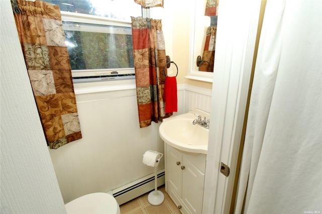 bathroom featuring toilet, tile patterned flooring, vanity, and a baseboard heating unit