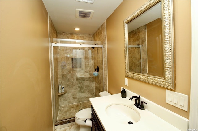 bathroom featuring vanity, toilet, and walk in shower