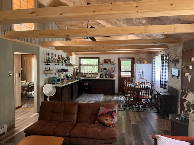 living room with sink, beam ceiling, a baseboard radiator, wooden ceiling, and hardwood / wood-style floors