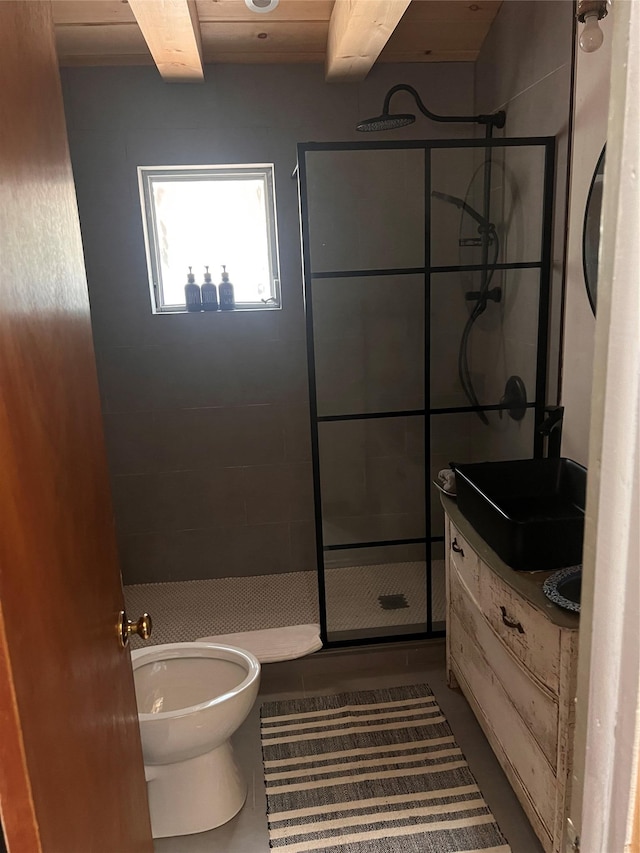 bathroom with a tile shower, tile patterned floors, toilet, vanity, and wood ceiling