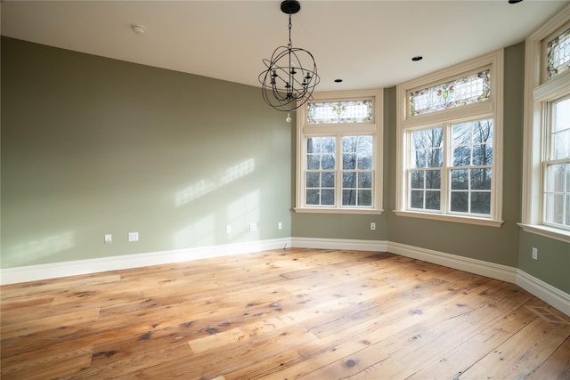 interior space with a chandelier and light hardwood / wood-style flooring