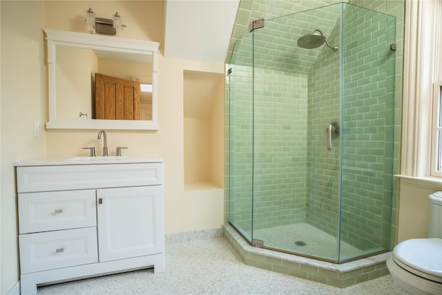 bathroom with tile patterned floors, vanity, toilet, and an enclosed shower