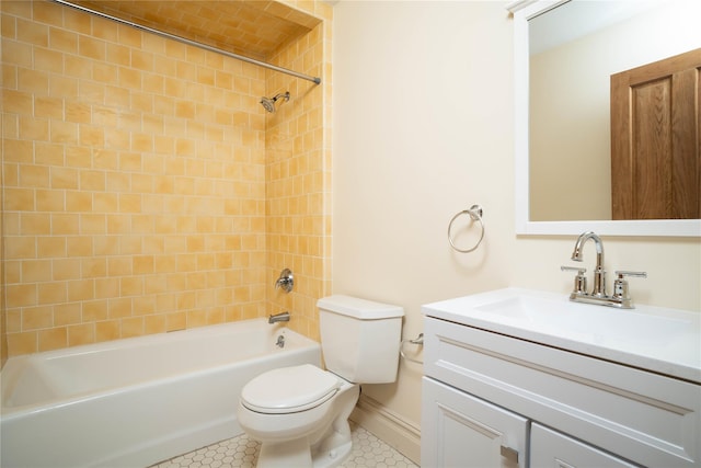 full bathroom featuring tiled shower / bath combo, toilet, and vanity