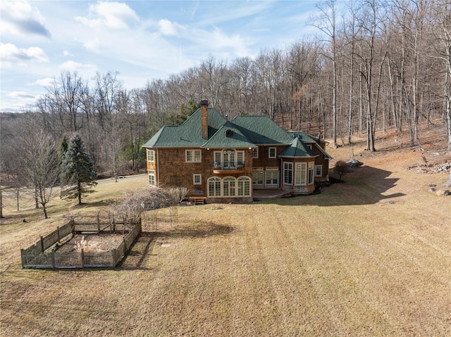 rear view of house with a yard