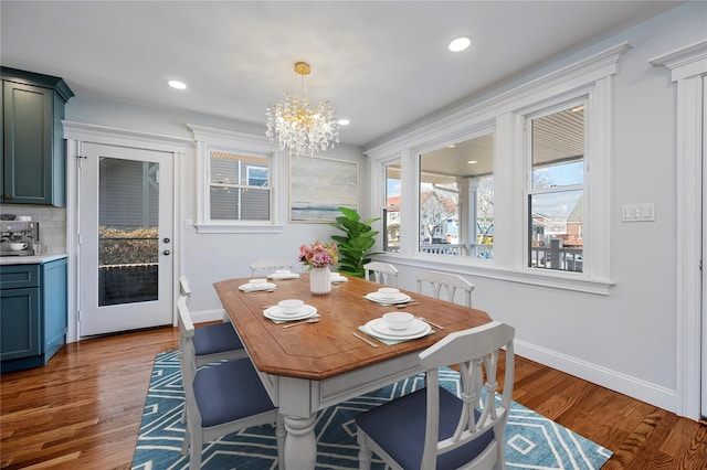 dining room featuring dark hardwood / wood-style flooring and a notable chandelier