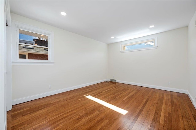 unfurnished room with hardwood / wood-style flooring