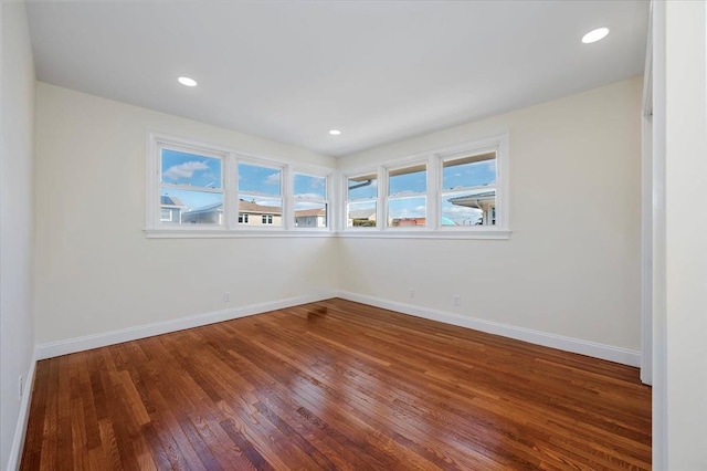 unfurnished room with wood-type flooring