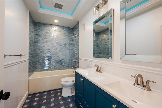 full bathroom featuring ornamental molding, toilet, vanity, and tiled shower / bath combo