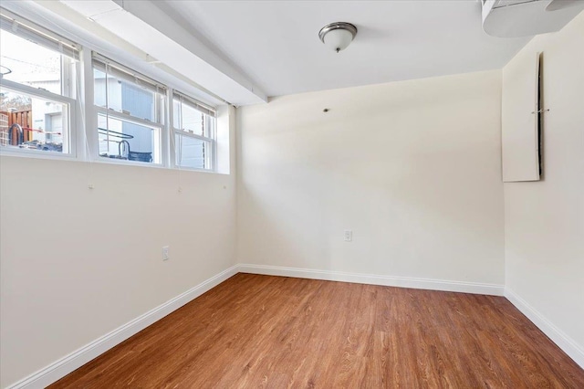 unfurnished room with wood-type flooring