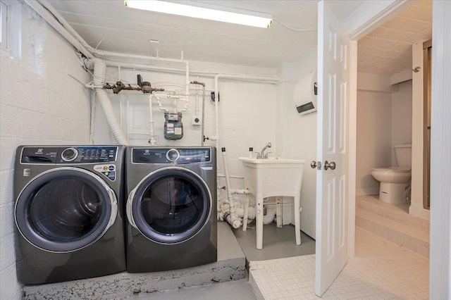 washroom with independent washer and dryer