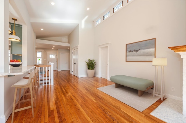 interior space with hardwood / wood-style flooring and a towering ceiling