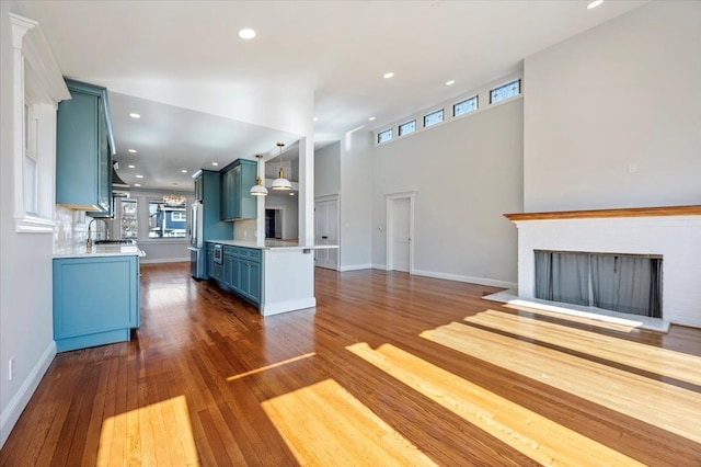 unfurnished living room featuring sink and dark hardwood / wood-style floors