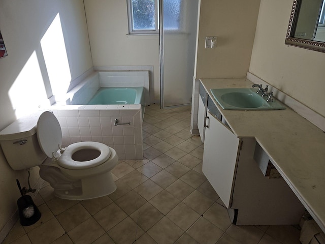 bathroom with a bathtub, tile patterned floors, vanity, and toilet