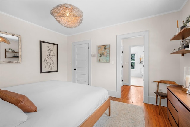 bedroom with ornamental molding and light wood-type flooring