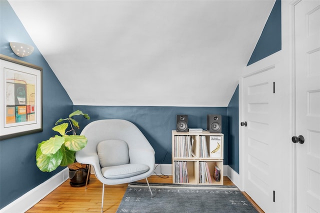 living area featuring hardwood / wood-style flooring and lofted ceiling