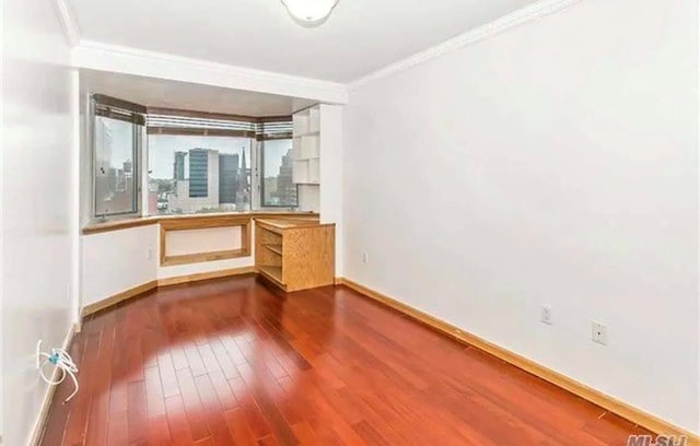 interior space featuring dark wood-type flooring and crown molding