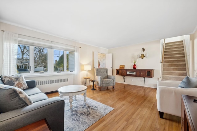 living room with radiator heating unit and light hardwood / wood-style flooring